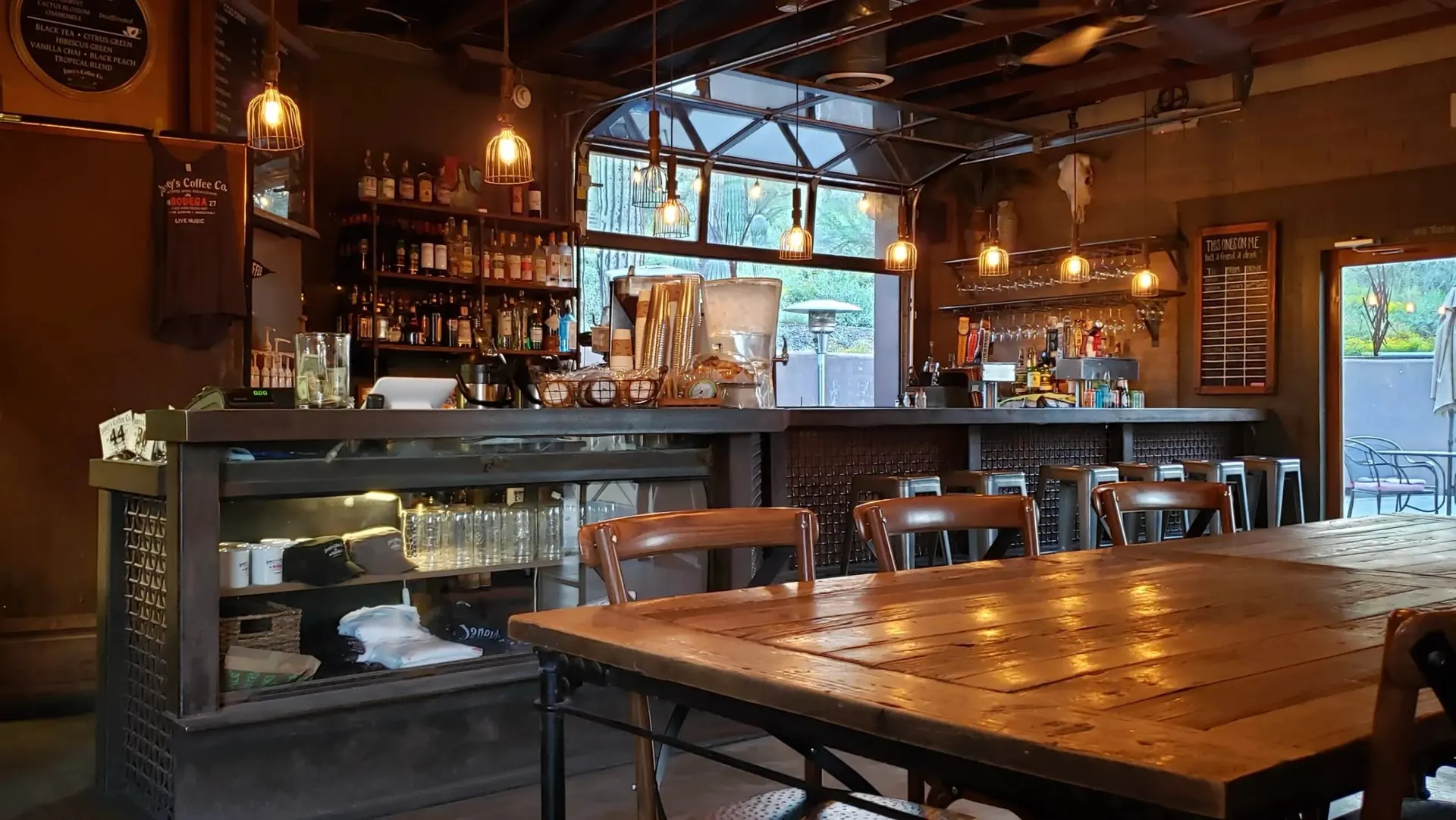 Janey’s wooden bar and tables beneath warm pendant lights